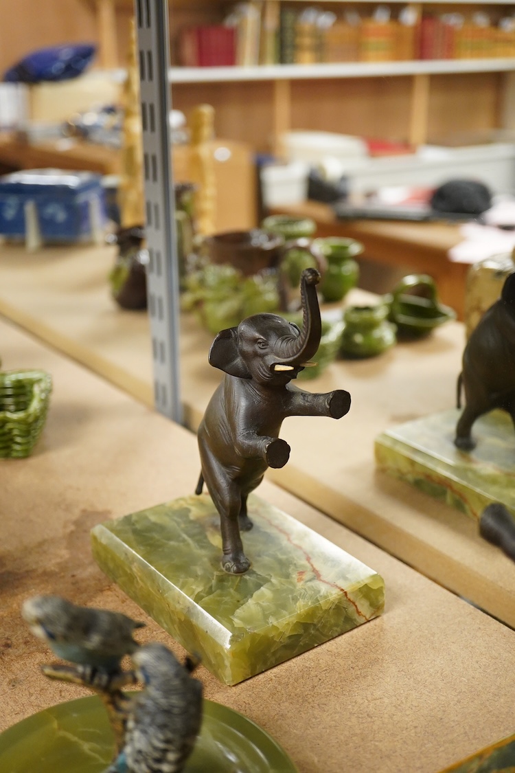 Two Art Deco bronze elephants and a cold painted bronze parakeet group, all on green onyx bases, tallest 17cm